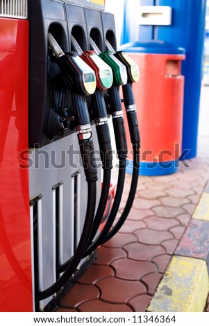 Gas station nozzles. Fuel and fossil gas consumption concept