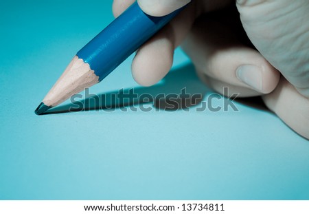 Big pencil in hand close up. Cool light with shadows, education concept