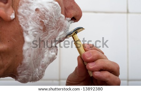 Man shaving moustaches with old razor blade