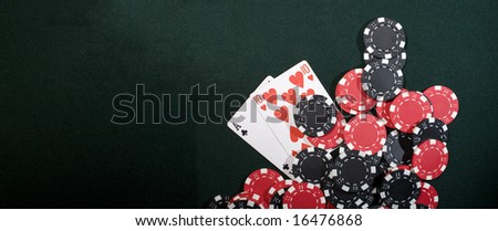 Casino chips on a green background and texas holdem poker cards. Vegas concept