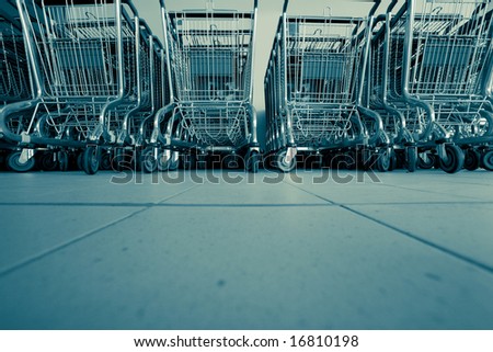 Shopping carts in supermarket in rows ready for consumers
