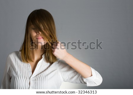 Woman pulling her hair. Healthy hair and hairstyle concept