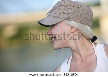 Outdoor portrait of beautiful young blond woman. Shallow DOF
