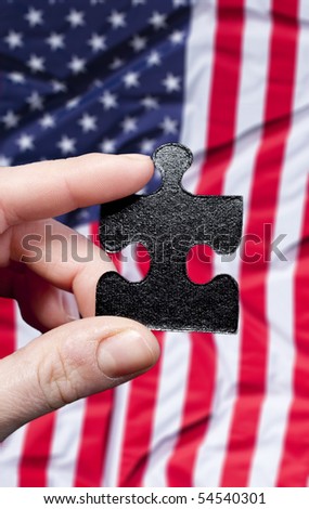Missing puzzle part in hand against American flag