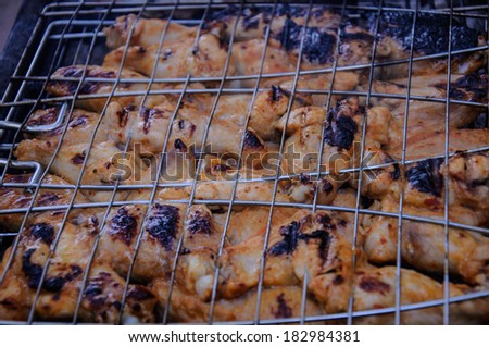 Barbecue chicken wings in smoke