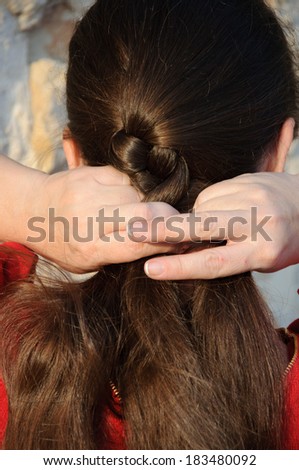 young pretty woman making hair braid