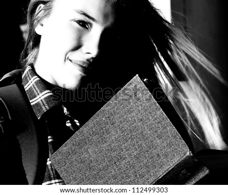 A black and white portrait of beautiful girl, Student with book or study, Open book