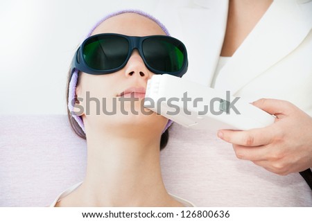 Young woman receiving electrolysis treatment on her upper lip