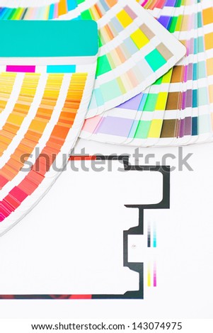 Graphic design and printing concept Pantone palette with printed package leftover