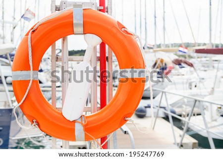 Life ring closeup with boats in the background