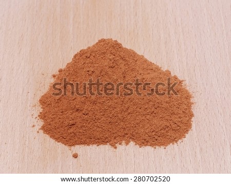 Heap of cat\'s claw plant powder (Uncaria tomentosa) in wooden plate