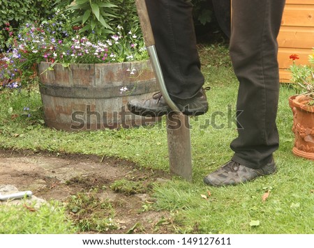 man edging path in garden