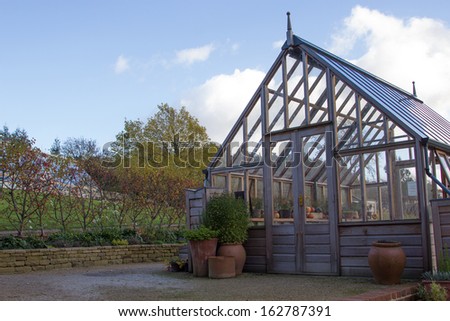 wooden greenhouse in autumn