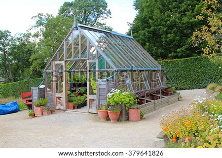 garden greenhouse with cold frame and pots