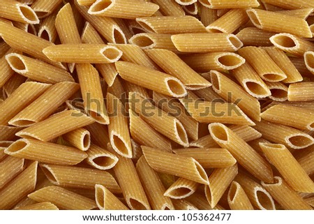 Raw bio whole grain pasta food background, deep focus fusion image.