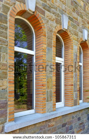 Windows on a sacral building in small city B a n n e u x, Belgium