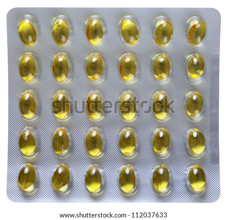 Close up of a pill blister with yellow pills, isolated on white background
