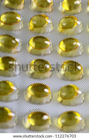 Close up of a pill blister with yellow pills