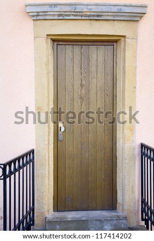 Vew of a modern  wooden door in old facade, city Luxembourg/Luxembourg, summer