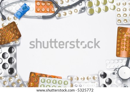 Medical frame made of pills and stethoscope isolated on white.