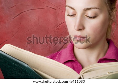 Woman reading a book. Red background.