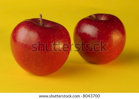 two apples on yellow background