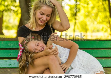 Happy Mom and Daughter Having Fun Outdoors, happy family