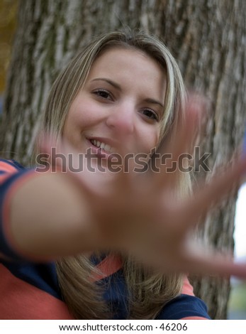 A young woman reaching out her hand.