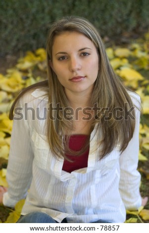 A young woman relaxing in the leaves.