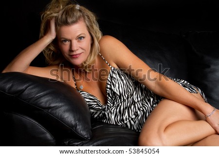 Beautiful woman on leather couch