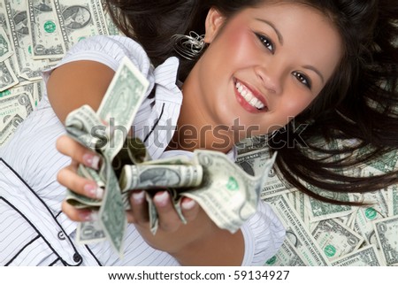 Smiling person laying in money