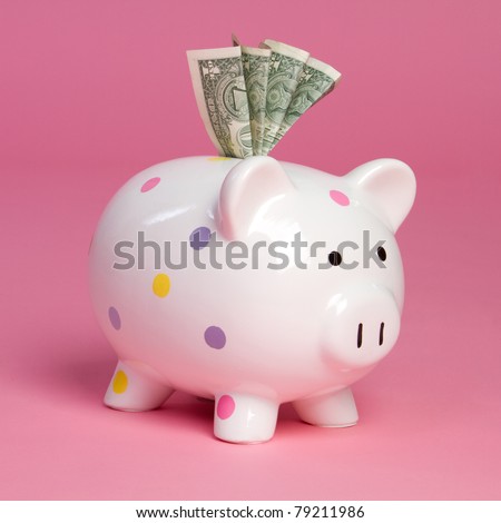 Pink piggy bank holding money