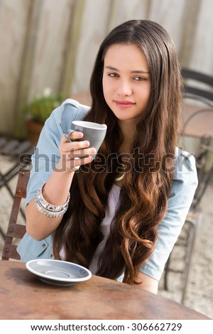 Beautiful young maori woman drinking coffee
