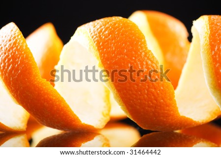 Spiral orange peel reflecting on black background