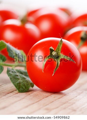 Cherry tomatoes on the wood background