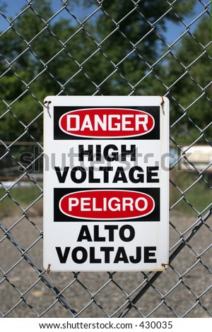 high voltage sign in english and spanish