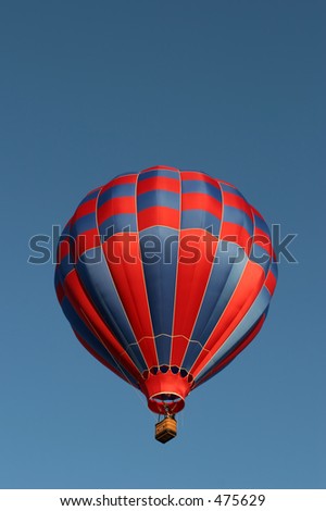 red and blue hot air balloon against a clear blue sky