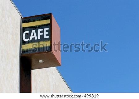 cafe sign on an old building, blue sky