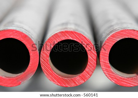 steel pipes - abstract close up of thick steel pipes for use in the oil industry. red paint indicates level of hardness. shallow depth of field.