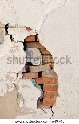 crumbling wall with revealed brick work