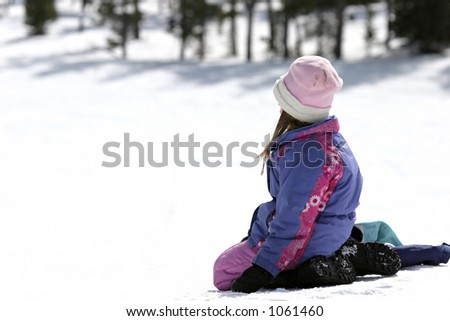 girl sitting in the snow, watching and waiting