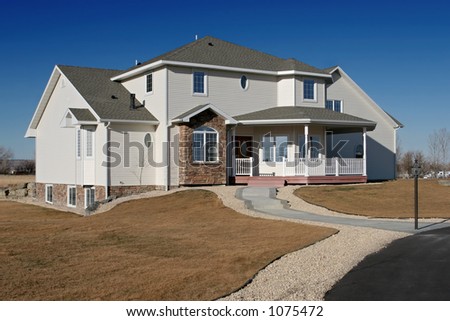new american home - brand new house on the outskirts of town against a blue sky