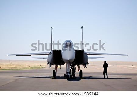 military aircraft - F-15 strike eagle on tarmac with pilot and technician