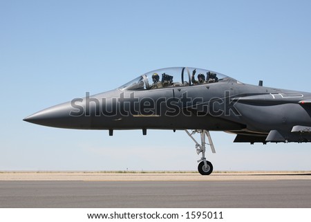 F-15 Strike Eagle taxiing to runway, closeup of cockpit with pilot and acknowledgement from the weapons systems officer