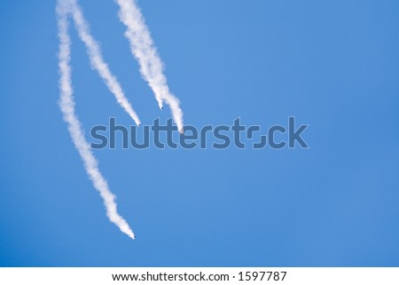 free fall - group of skydivers with smoke trails plummeting towards the ground