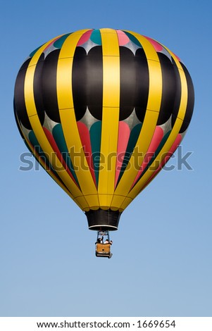 hot air balloon - colorful balloon against blue sky, passengers leaning out and looking at ground