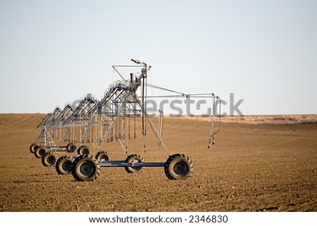 irrigation system lies motionless on a cold, barren field in december
