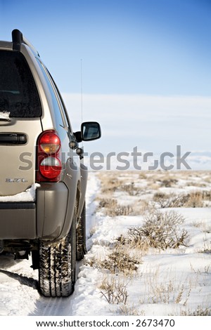 SUV on a remote snowy road, northern wyoming.