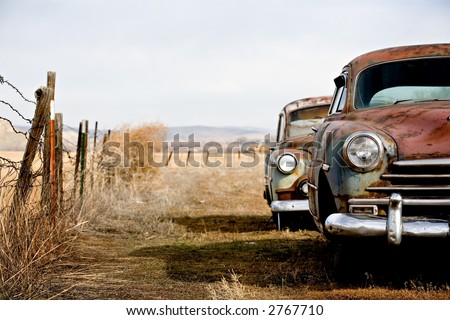 stock photo vintage cars abandoned and rusting away in rural wyoming