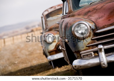 stock photo abandoned cars two vintage cars angled closeup with focus on
